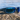 Sunglasses with blue lenses on a rock by a body of water
