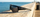 Black sunglasses on a wooden pier with ocean in the background